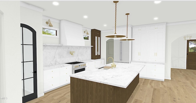 kitchen featuring white cabinetry, sink, a kitchen island with sink, and high end stove