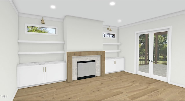 unfurnished living room with crown molding, a fireplace, french doors, and light wood-type flooring