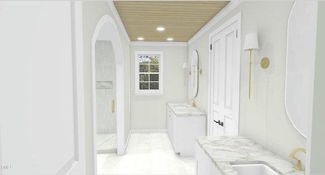 bathroom with vanity, ornamental molding, and a shower with shower door