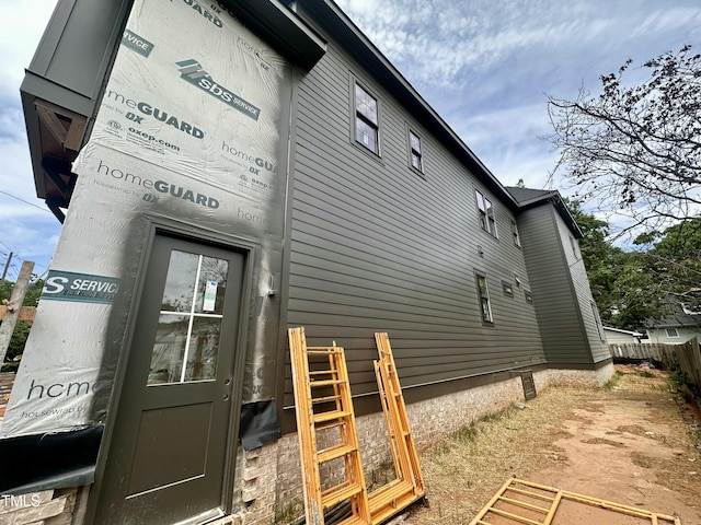 view of side of home with fence