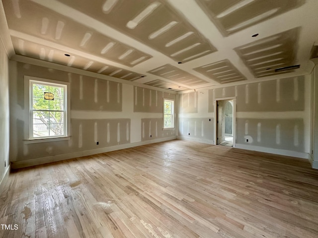 unfurnished living room featuring baseboards and wood finished floors