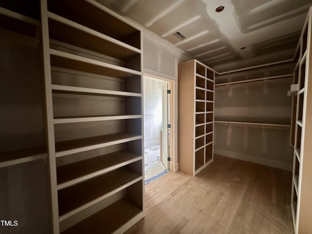 spacious closet featuring wood finished floors