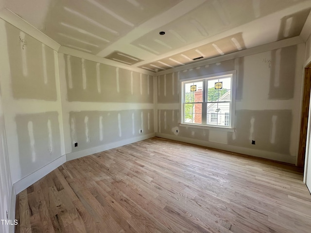 unfurnished room featuring baseboards and wood finished floors