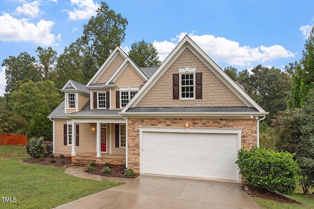 craftsman inspired home featuring a garage, a front lawn, and covered porch