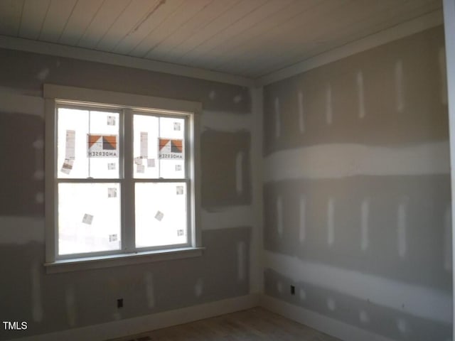 unfurnished room with hardwood / wood-style floors, a wealth of natural light, and wood ceiling