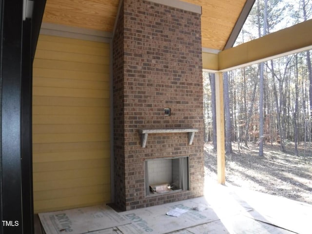 view of patio featuring an outdoor brick fireplace