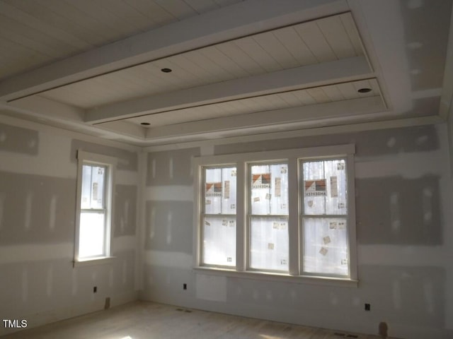 spare room featuring beamed ceiling