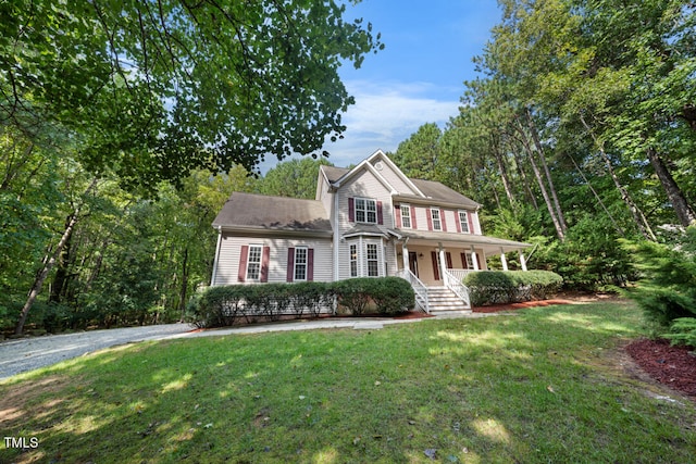 view of front of property with a front lawn and covered porch