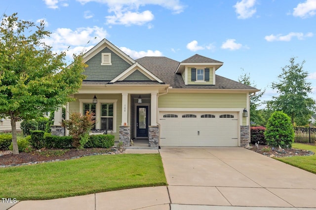 108 Boone St, Chapel Hill, NC 27516 - craftsman-style house featuring a garage, a front lawn, covered porch, stone siding, and driveway