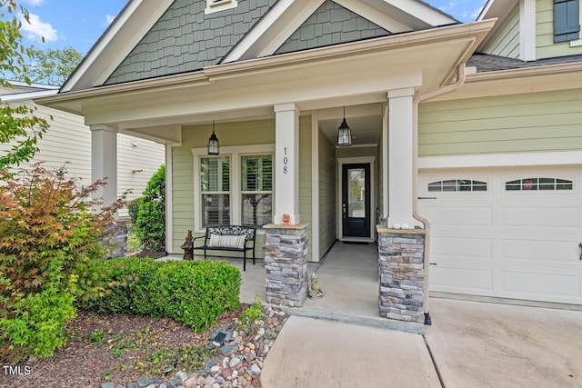 108 Boone St, Chapel Hill, NC 27516 - property entrance with a porch, an attached garage, and concrete driveway