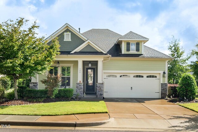 108 Boone St, Chapel Hill, NC 27516 - craftsman-style house with roof with shingles, an attached garage, a front lawn, stone siding, and driveway