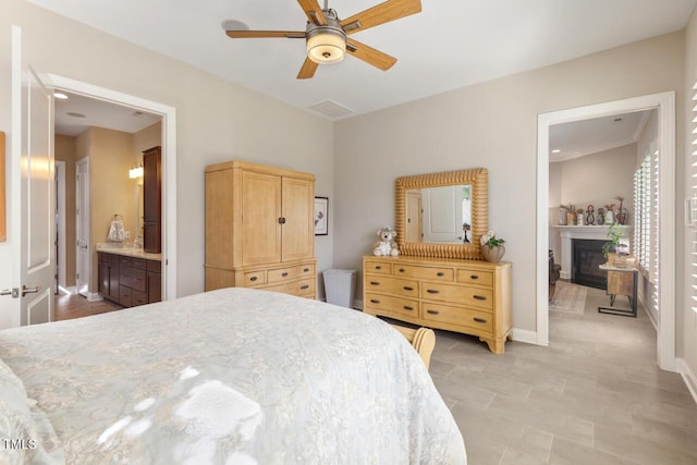 108 Boone St, Chapel Hill, NC 27516 - bedroom featuring a glass covered fireplace, baseboards, light tile patterned floors, a ceiling fan, and ensuite bath