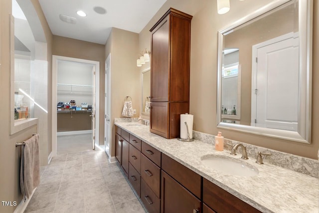 108 Boone St, Chapel Hill, NC 27516 - bathroom featuring double vanity, a sink, tile patterned flooring, and a spacious closet