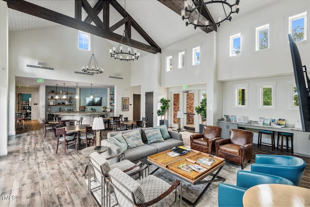 108 Boone St, Chapel Hill, NC 27516 - living room with high vaulted ceiling, wood-type flooring, beam ceiling, and a notable chandelier