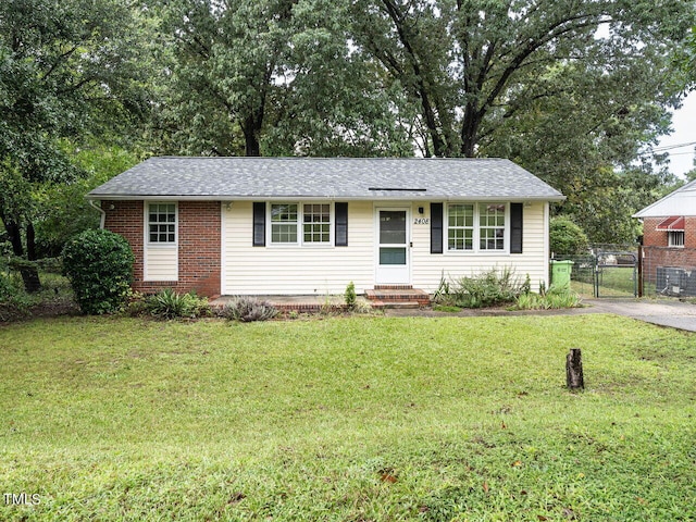 ranch-style house with a front lawn and central air condition unit