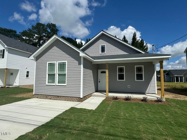 view of front of house featuring a front lawn and a patio area