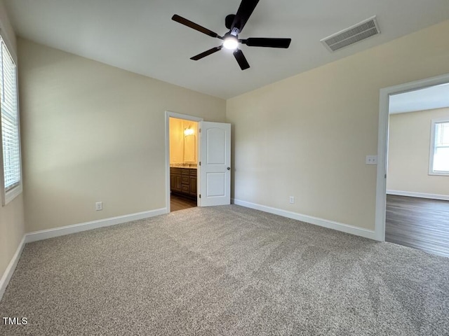 1005 Sunnybrook Rd S, Wilson, NC 27893 - unfurnished bedroom featuring a ceiling fan, ensuite bathroom, baseboards, visible vents, and carpet
