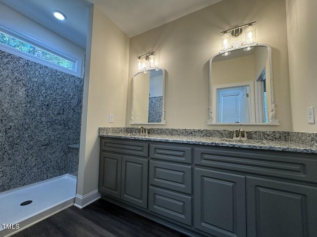 1005 Sunnybrook Rd S, Wilson, NC 27893 - bathroom featuring a sink, wood finished floors, walk in shower, baseboards, and double vanity