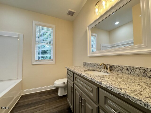 full bathroom with independent shower and bath, wood-type flooring, vanity, and toilet