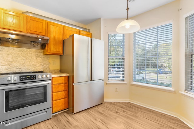 kitchen with extractor fan, light hardwood / wood-style floors, decorative light fixtures, backsplash, and appliances with stainless steel finishes