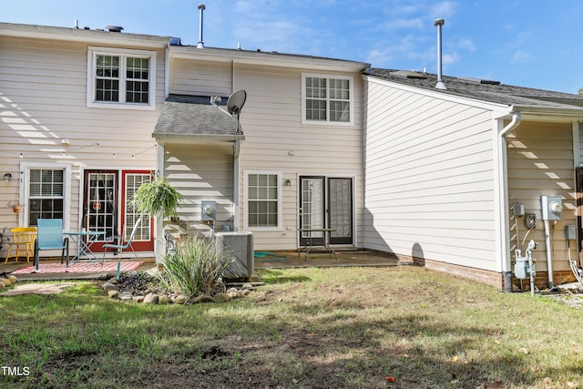 back of property featuring central AC, a yard, and a patio area