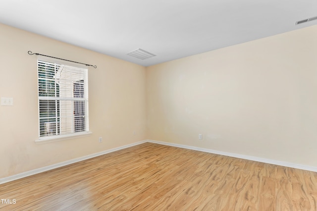 spare room with light wood-type flooring