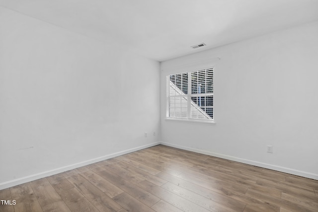 empty room with light hardwood / wood-style floors