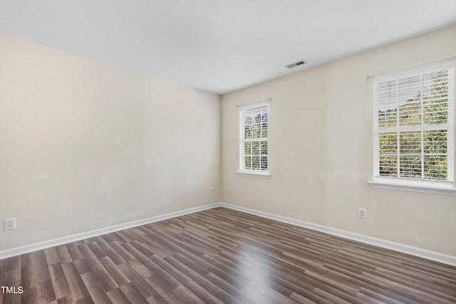 unfurnished room with dark hardwood / wood-style floors