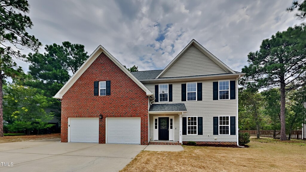 view of front of property with a garage and a front lawn