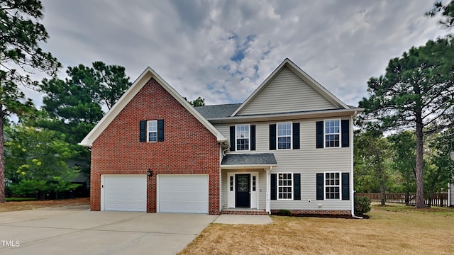 view of front of property with a garage and a front lawn