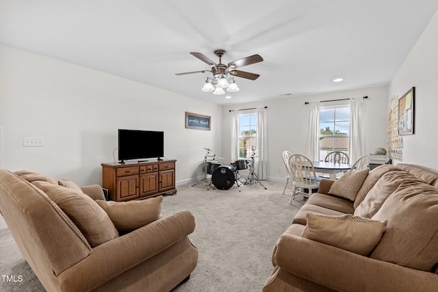 carpeted living room featuring ceiling fan