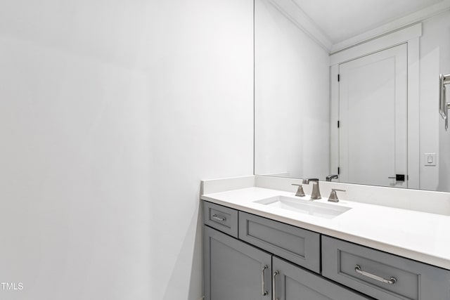 bathroom with ornamental molding and vanity