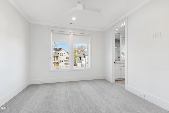 unfurnished room with ceiling fan, crown molding, and light carpet