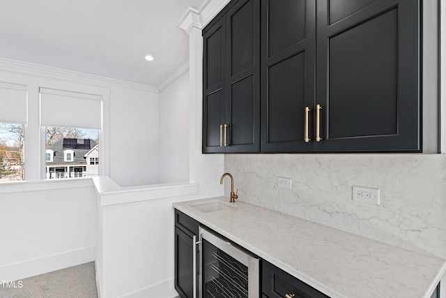 bar with light stone counters, tasteful backsplash, beverage cooler, ornamental molding, and sink