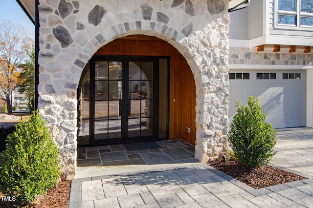 doorway to property with french doors and a garage