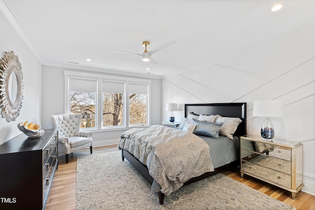 bedroom with hardwood / wood-style flooring, ceiling fan, and crown molding