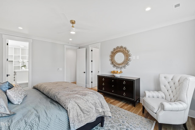 bedroom featuring ceiling fan, light wood-type flooring, and crown molding