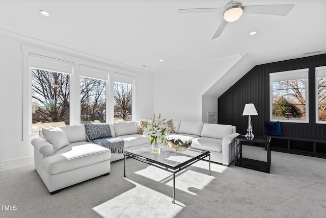 living room with ornamental molding, ceiling fan, and light carpet