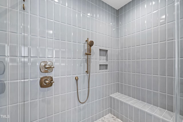 bathroom with tiled shower