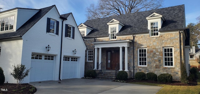 new england style home featuring a garage