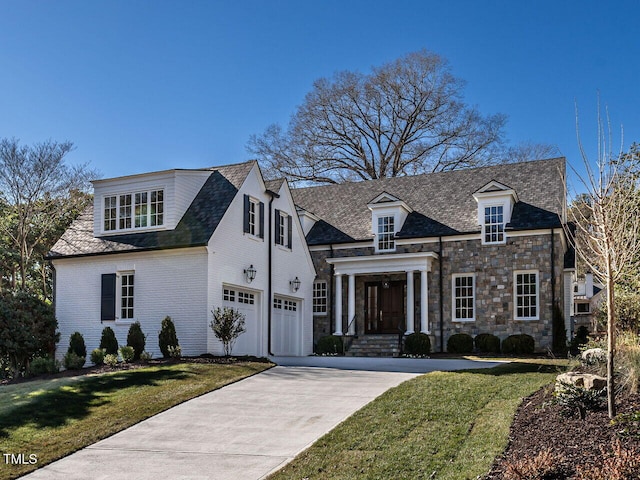 view of front of home featuring a garage and a front lawn