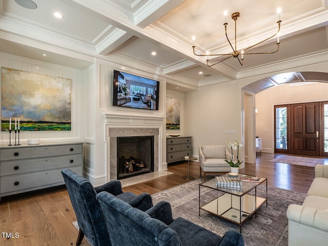 living room with crown molding, beamed ceiling, coffered ceiling, and hardwood / wood-style flooring