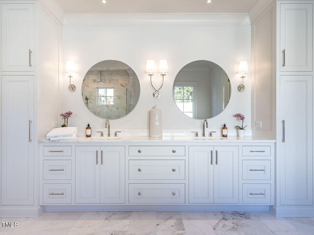 bathroom featuring vanity and ornamental molding