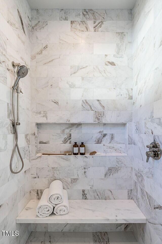 bathroom with a tile shower