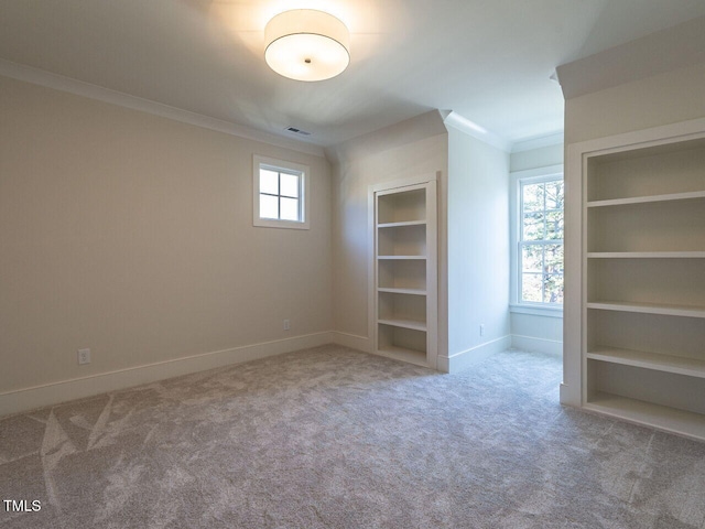 interior space with light carpet, built in features, and ornamental molding