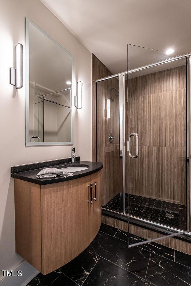 bathroom with vanity and a shower with shower door