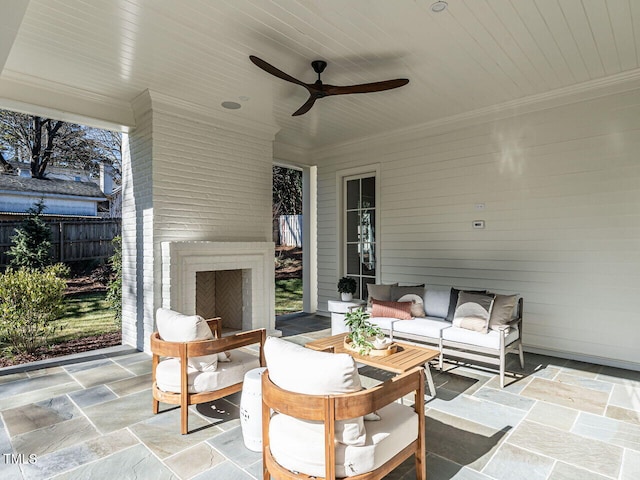 view of patio / terrace featuring an outdoor living space with a fireplace and ceiling fan