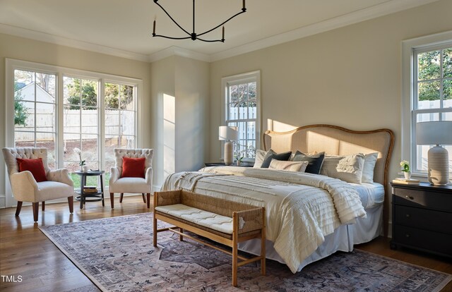 1307 Mayfair Rd, Raleigh, NC 27608 - bedroom featuring a chandelier, dark wood finished floors, and ornamental molding