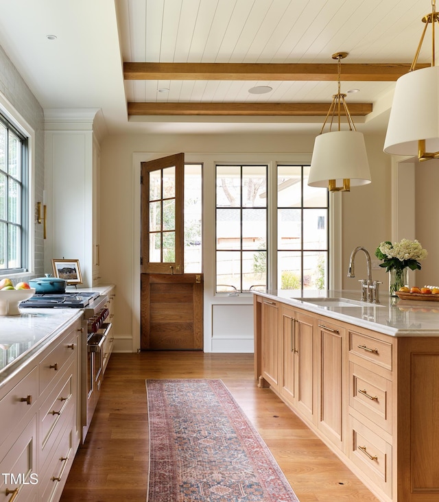 1307 Mayfair Rd, Raleigh, NC 27608 - kitchen featuring stainless steel range, light countertops, light wood-type flooring, and a wood ceiling with exposed beams