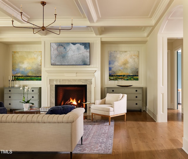 1307 Mayfair Rd, Raleigh, NC 27608 - living room featuring wood finished floors, a chandelier, a fireplace, crown molding, and beamed ceiling